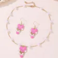 Detail shot of pink enamel heart hot air balloon necklace and earrings set with faux pearls. - Pearl Hot Air Balloon Style