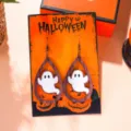 Detailed view of Halloween ghost teardrop earrings on a festive orange display card - Wooden Teardrop Ghost (2890-1)