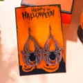 Detailed view of Halloween spider wooden drop earrings displayed on an orange gift card - Wooden Teardrop Spider (2890-6)
