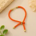 Oranje Milan touw gevlochten verstelbare armband met gouden metalen buisjes voor sieraden. - Groot Oranje