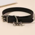 Close-up detail of the black leather punk choker necklace with a bone pendant and metal buckle. - Black (NZ3217heise)