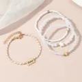 Detailaufnahme des mehrschichtigen Sternzeichen- und Perlenarmband-Sets für Frauen. - Wassermann / 4-teiliges Set