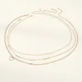 Detailed view of trendy multi-layer gold waist chain featuring sparkling heart charms. - Gold