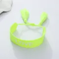 Close-up detail shot of a neon green woven braided bracelet with cute tassels and LOVE text. - Fluorescent Green