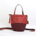 Stylish genuine leather bucket bag with woven bottom, top handle and adjustable strap. - Wine Red - Embossed