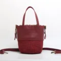 Red leather and woven straw bucket bag with top handle and detachable crossbody strap SKU. - Burgundy