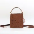 Vintage embossed genuine cowhide leather bucket bag with top handle and shoulder strap. - Tan