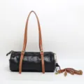 Borsa a tracolla cilindrica nera vintage da donna con cinturini e manico in pelle. - Nero