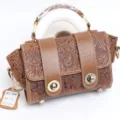Vintage embossed genuine leather handbag with top handle and turn-lock closure for women. - A14