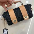 Premium black embossed top layer cowhide handbag with retro tan leather straps and metal locks. - Black
