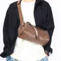 Stylish men's brown cylindrical crossbody bag worn by model, perfect for casual daily streetwear. - Coffee Gray