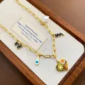 Detailed shot of gold titanium steel paperclip chain necklace with pearl and colorful enamel charms. - Heart Necklace (03-E26) / Gold