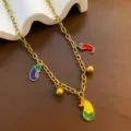 Gold-tone titanium steel chain necklace featuring colorful enamel vegetable charms detail. - Corn Necklace (05-E24) / Gold