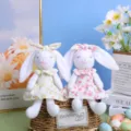 Detailed view of cute Easter long ear bunny plush dolls in floral dresses. Perfect spring decor. - Set