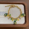 Gold-tone titanium steel avocado charm bracelet with crystal beads and zircon details - Avocado Bracelet (07-E28) / Gold