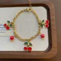 Gold-tone chain bracelet featuring lovely red enamel cherry and bead charms, sweet jewelry piece. - Cherry Bracelet (07-E22) / Gold