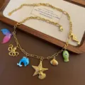 Gold titanium steel ocean charm necklace with multi-element pendants for women variant. - Gradient Fish Tail Necklace (03-E28) / Gold