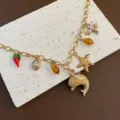 Ocean style DIY gold chain necklace with cute charms like dolphin, starfish, and amber beads. - Dolphin Pendant Necklace (04-E25) / Gold