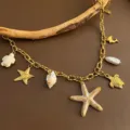 Ocean style gold chain necklace with multiple cute starfish turtle shell charms for women - Starfish Necklace (04-E26) / Gold