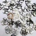 Close-up detail of 12mm carved mother of pearl shell flower beads, perfect for DIY jewelry. - 10mm