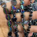 Close-up detail shot showing colorful iridescent butterfly and oval loose beads for DIY jewelry. - Oval / 9x12mm / AB Color Series