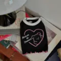 Close-up detail of the black pet vest featuring cute bear graphic and pink heart print. - XS / Black