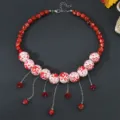 Detailed shot of Halloween red and white beaded choker necklace with tassels for women. - Red