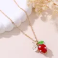 Gold-tone chain necklace featuring a cute red resin strawberry pendant and white flower charm. - Red Strawberry