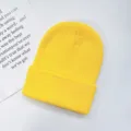 Solid color knitted winter beanie hat for adults, warm cozy yellow skull cap for skiing. - One Size / Yellow