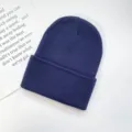 Classic solid dark blue winter knitted beanie hat for adults, warm and stylish cuff design. - One Size / Navy Blue