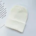 Plain white knitted beanie hat, warm pull-on winter cold cap for adults, minimal style detail. - One Size / White