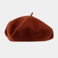 Detailed view of the solid color wool beret, featuring a soft texture and classic design. - Recommended Head Circumference 56-59 cm (Elastic, Non-adjustable) / Brick Red