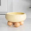 Elevated ceramic pet bowl with wooden ball feet, ideal for cats and small dogs daily feeding. - Locke Yellow - Single Layer Wooden Ball Stand