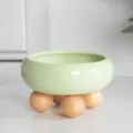 Elevated ceramic pet bowl with wooden ball feet, perfect for cats and small dogs feeding. - Dian Green - Single Layer Wooden Ball Stand