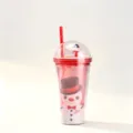 Detail view of a festive Christmas double-walled straw cup with a cute snowman figure and glitter - 650ml / Snowman