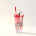 Detailed view of a festive Christmas straw cup featuring a snowman design and glittery dome lid. - 650ml / Snowman and Tree