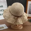 Handgewebter beiger Strohhut für den Strand, verziert mit einer braunen Lederschleife - Beige