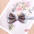 Detail shot of the men's paisley bow tie featuring dual-fabric design and elegant silver satin. - Color 007