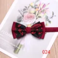 Detail shot of a stylish men's two-tone bow tie with classic red paisley and burgundy fabric. - Color 024