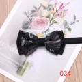Detail shot of men's paisley patterned two-tone bow tie with elegant floral background. - 034