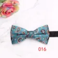 Detailed view of turquoise paisley bow tie with elegant floral pattern for formal wear. - Teal