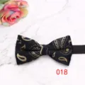 Close-up detail of the classic black and gold paisley bow tie, showcasing fine woven fabric. - Black Gold Paisley