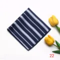 Close-up view of a stylish navy blue pocket square with white diagonal stripes, detailed fabric texture. - Style 22