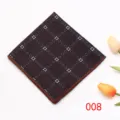 Close-up detail of dark brown geometric patterned pocket square with neat stitched edge. - Color 008