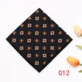 Detailed view of the black pocket square with elegant orange and white geometric patterns. - 012