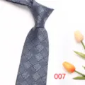 Detail view of a classic blue woven men necktie with geometric texture, elegant design. - Color 007