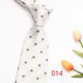 Detail view of a classy white business necktie with subtle square jacquard pattern and tulips. - Color 014