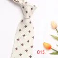 Close-up detail of men's elegant geometric patterned tie with floral props on white background. - Color 015