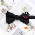 Detail view of a classic black double-layer men's bow tie with glittering rhinestone flower decor. - Arrow Shape / Black