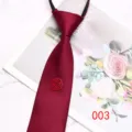 Detailed view of the burgundy zipper tie with a festive Chinese double happiness ornament. - Color 003